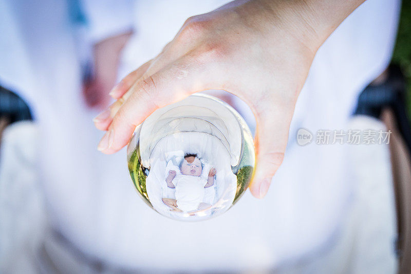 Cute newborn baby in crystal ball